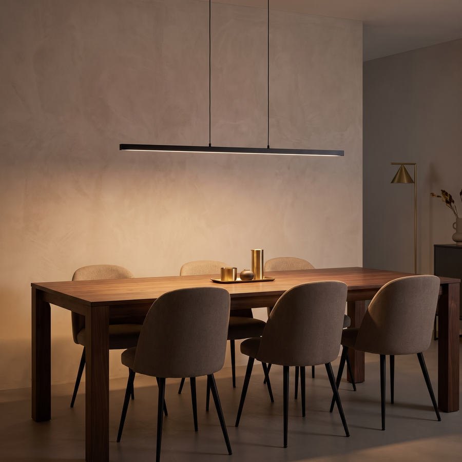 Linear pendant light above a walnut dining table