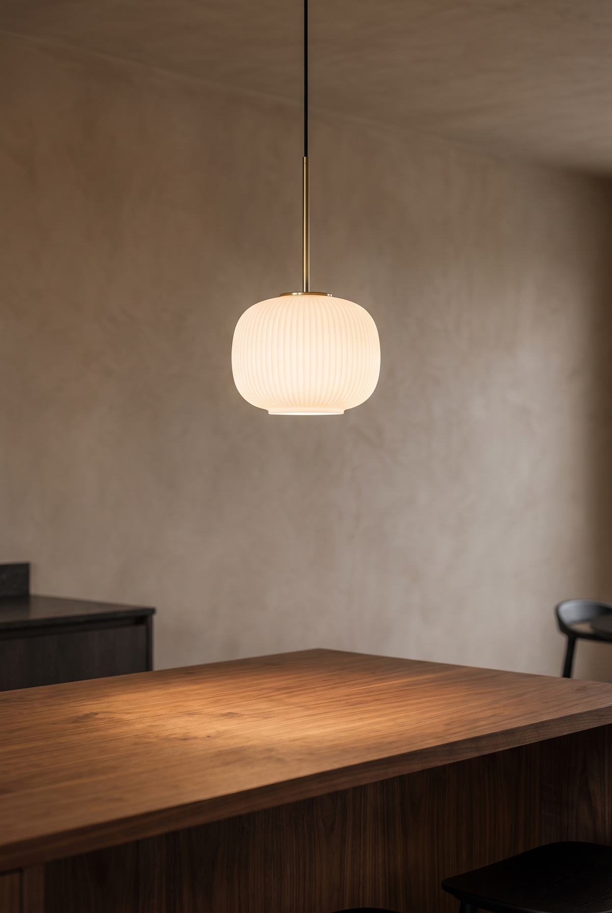 BRAND-02-PENDANT — opal glass pendant above a walnut island