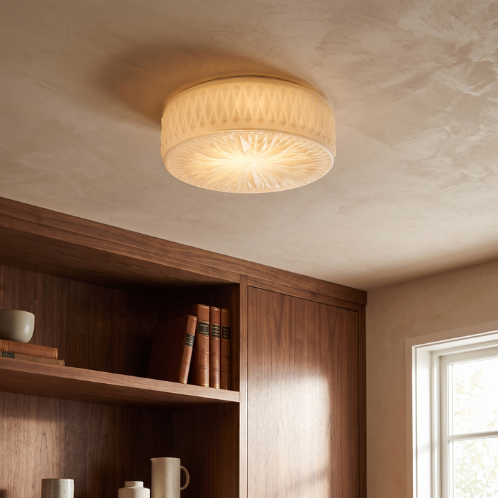 Adler Ceiling Light mounted on a plaster ceiling in a contemporary den, showing the diamond-cut glass texture and warm ambient glow.