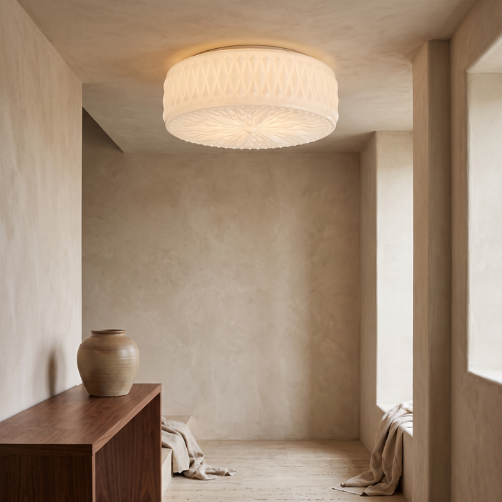 Adler Ceiling Light in White, a frosted white glass flush-mount fixture with diamond-cut texture, installed above a console table in a contemporary entryway.