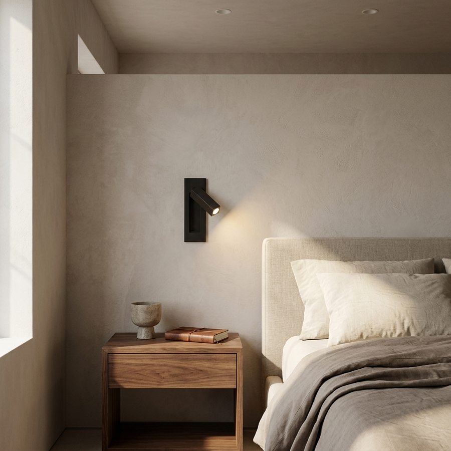 Embedded Bedside Sconce in Matt Black, installed beside a bed in a contemporary interior.