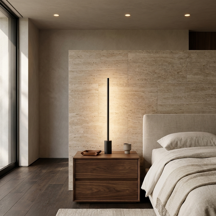 Luma Rod Portable Rechargeable Sconce in Black, on a nightstand in a contemporary bedroom.