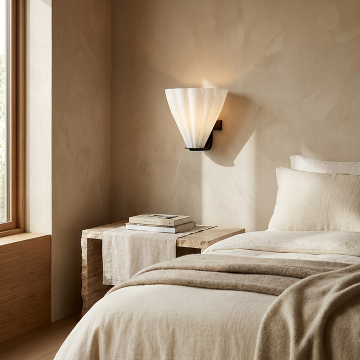 Fan Shaped Glass Wall Sconce shown beside a bed in a bedroom