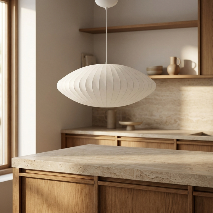 NYRVELA Crisscross Bubble Pendant Light hanging above a kitchen island with natural stone countertop