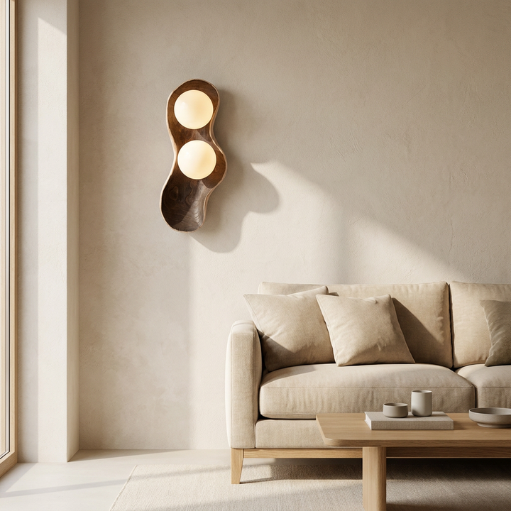 NYRVELA Dualis Rootlight Wall Lamp as a living room wall accent above a sofa