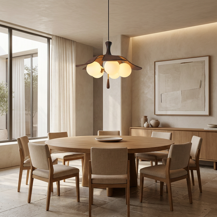 Solyntha Pendant Light hanging above a round dining table, wood petals surrounding glowing glass orbs